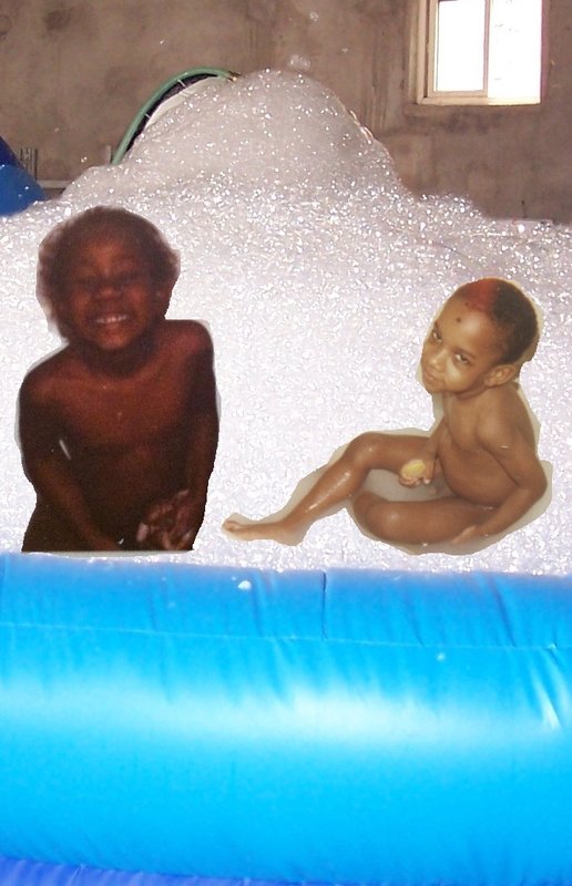 two black kids in a tub of foam.